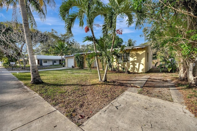 view of front of house featuring a front yard and a garage