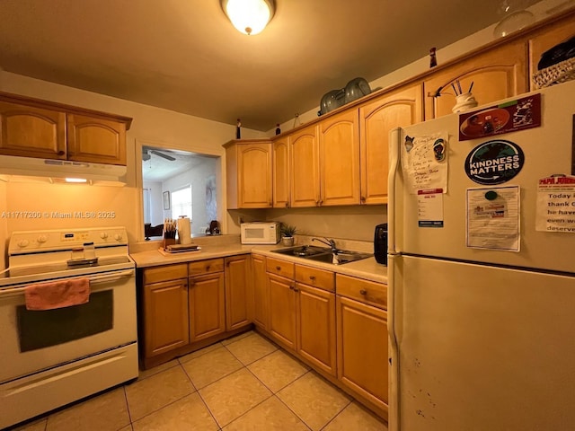 kitchen with light tile patterned flooring, white appliances, and sink