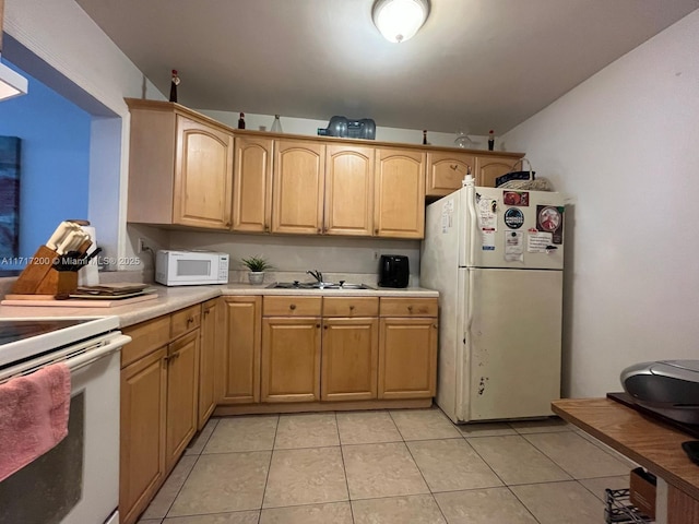 kitchen featuring light brown cabinets, white appliances, light tile patterned floors, and sink