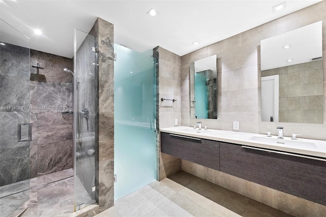 400 Alton Rd Unit 509, Miami Beach, FL 33139 - full bathroom with tile walls, double vanity, and a stall shower