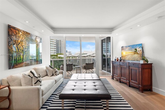 living room with floor to ceiling windows and light hardwood / wood-style floors