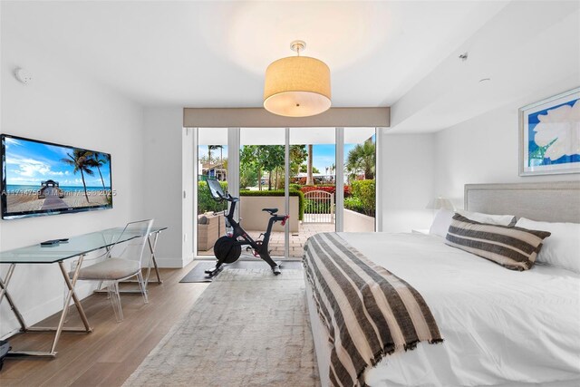 bedroom featuring access to exterior and light hardwood / wood-style flooring