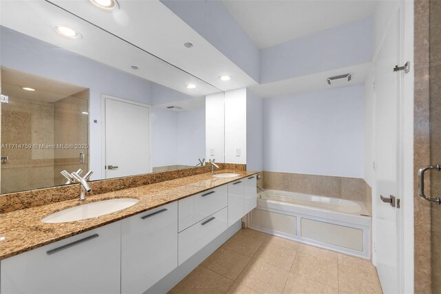 bathroom with plus walk in shower, tile patterned flooring, and vanity