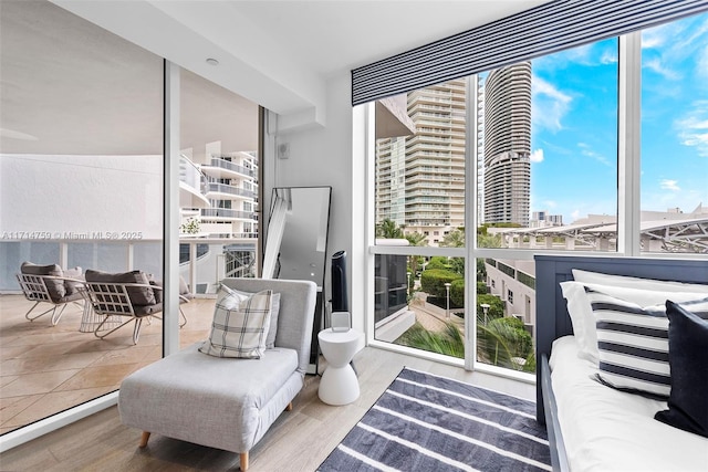 400 Alton Rd Unit 509, Miami Beach, FL 33139 - sitting room with expansive windows, a view of city, healthy amount of natural light, and wood finished floors