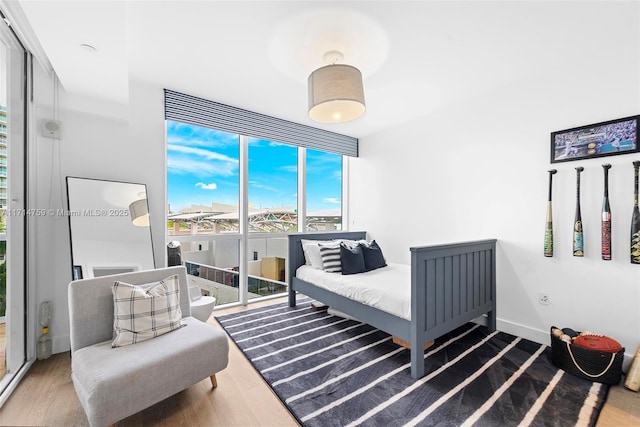 400 Alton Rd Unit 509, Miami Beach, FL 33139 - bedroom featuring wood finished floors and a wall of windows