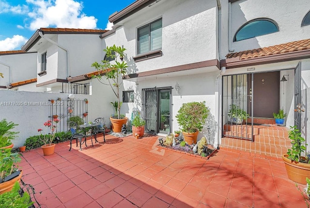 rear view of property featuring a patio area