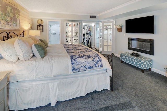 carpeted bedroom featuring french doors, ornamental molding, a spacious closet, connected bathroom, and a closet