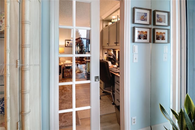 office area with hardwood / wood-style flooring and a wall of windows