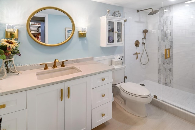 bathroom with toilet, vanity, and walk in shower