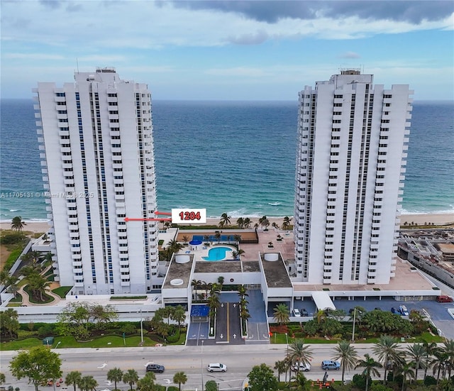 birds eye view of property featuring a view of the beach and a water view