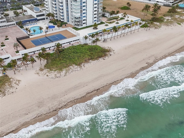 bird's eye view featuring a water view and a beach view