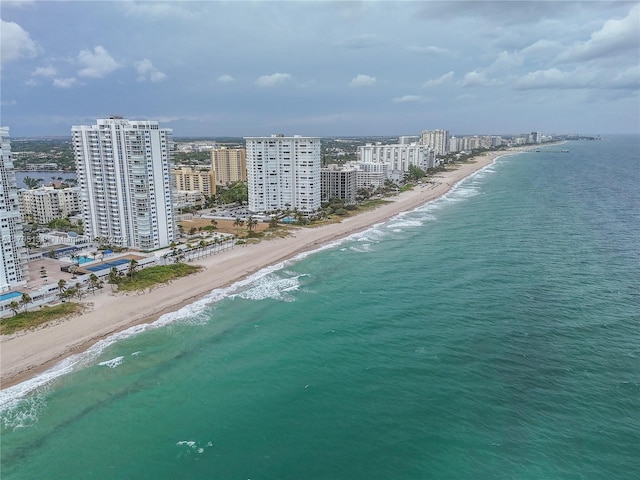 drone / aerial view featuring a view of the beach and a water view