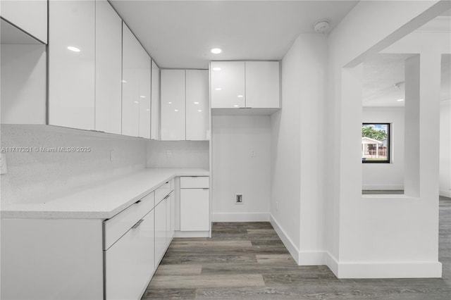 clothes washing area featuring dark hardwood / wood-style flooring