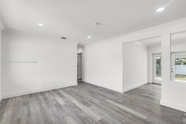 unfurnished room featuring wood-type flooring and ornamental molding