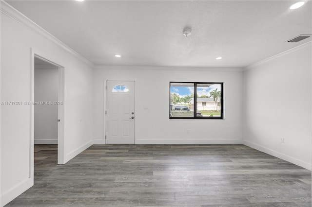 foyer with dark hardwood / wood-style floors and ornamental molding