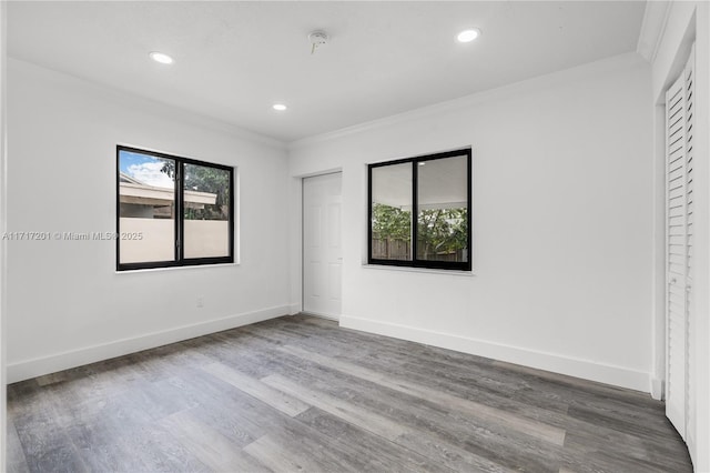 unfurnished bedroom with crown molding and hardwood / wood-style flooring