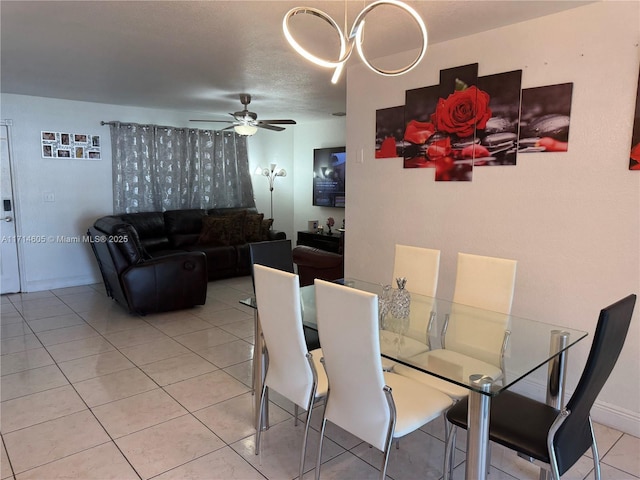 dining room with ceiling fan, light tile patterned flooring, and baseboards