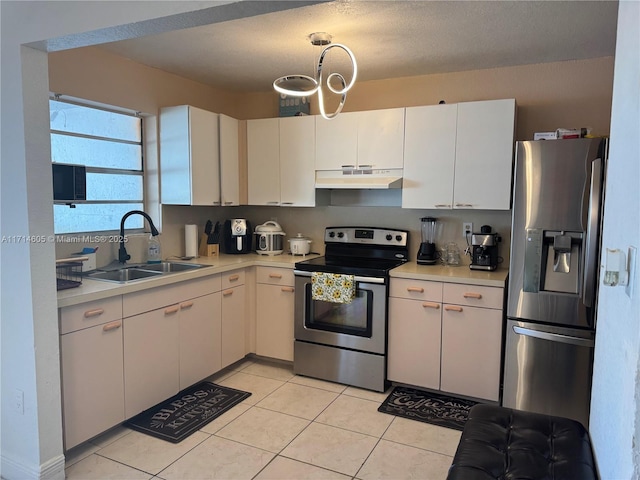 kitchen featuring stainless steel appliances, light countertops, light tile patterned flooring, a sink, and under cabinet range hood