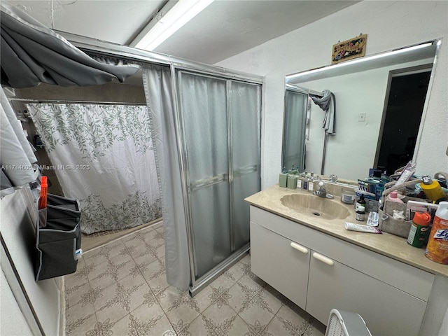 bathroom with a shower with curtain, vanity, and tile patterned floors