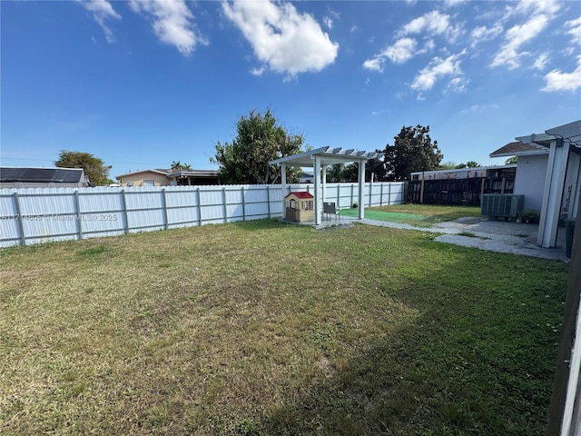 view of yard with cooling unit, a fenced backyard, and a pergola