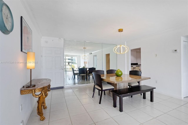 dining area featuring light tile patterned flooring and ornamental molding