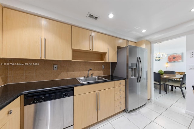 kitchen with light brown cabinetry, stainless steel appliances, light tile patterned floors, and sink