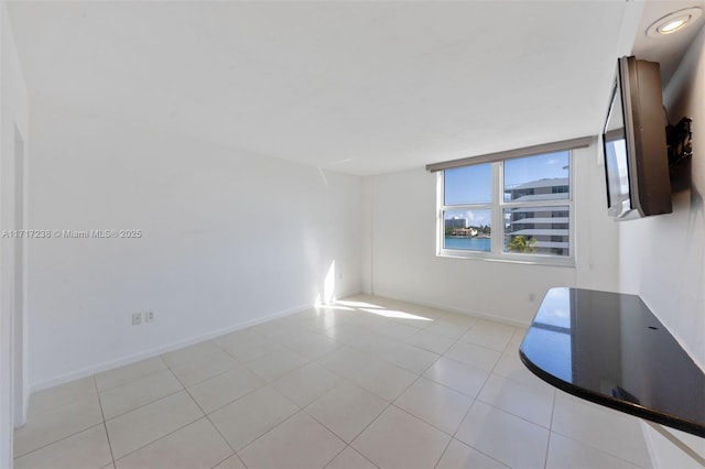 spare room featuring light tile patterned flooring