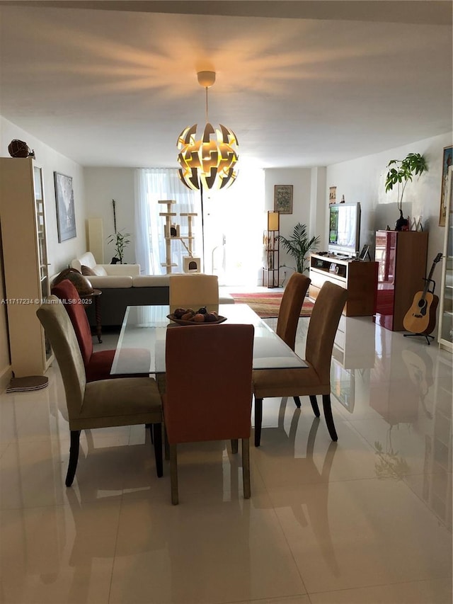 tiled dining area with a notable chandelier