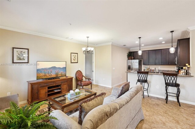 living room with a notable chandelier, sink, and crown molding