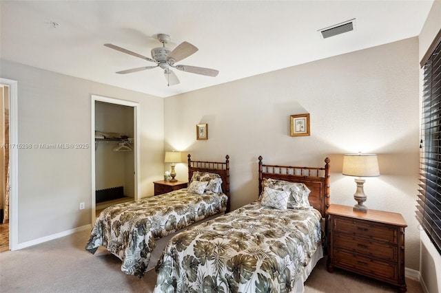 bedroom featuring carpet, a closet, ceiling fan, and a spacious closet