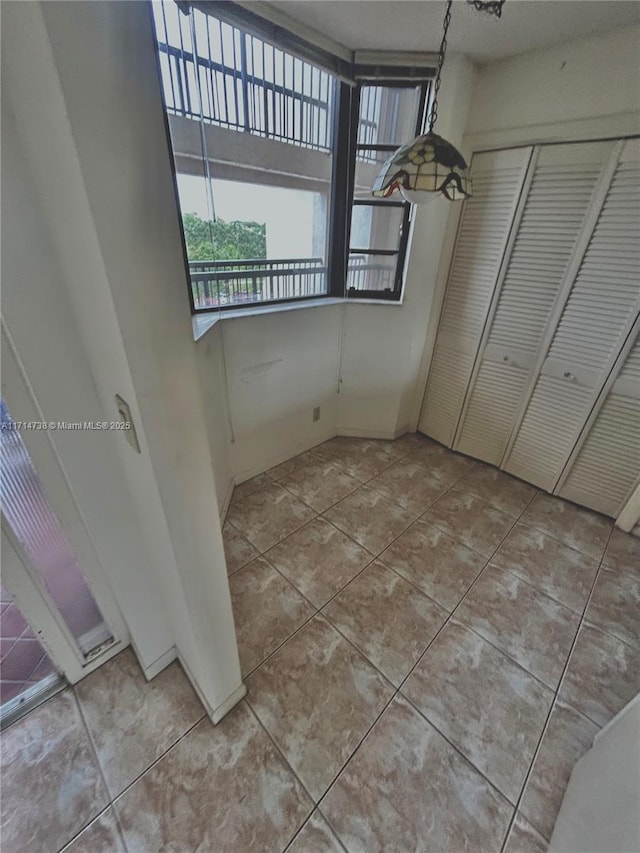 unfurnished dining area with light tile patterned flooring