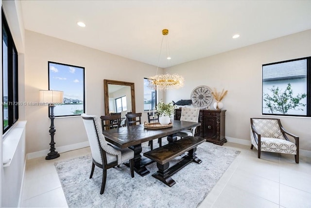 tiled dining area featuring an inviting chandelier