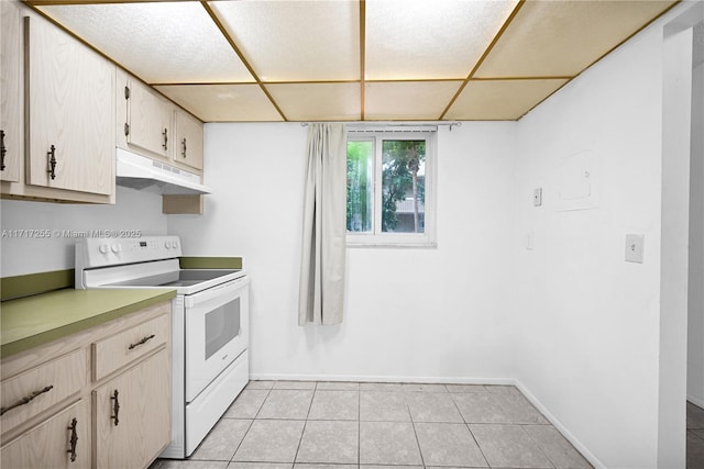 kitchen with a drop ceiling, electric stove, and light tile patterned floors