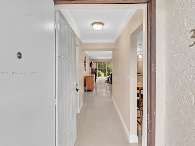 corridor featuring ornamental molding and light tile patterned flooring