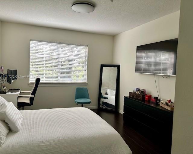 bedroom featuring dark wood-type flooring