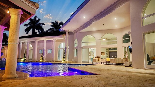 pool at dusk with a gazebo, grilling area, and a patio area