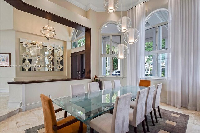 dining space with ornamental molding and a wealth of natural light