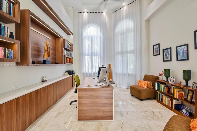 home office featuring a towering ceiling and french doors