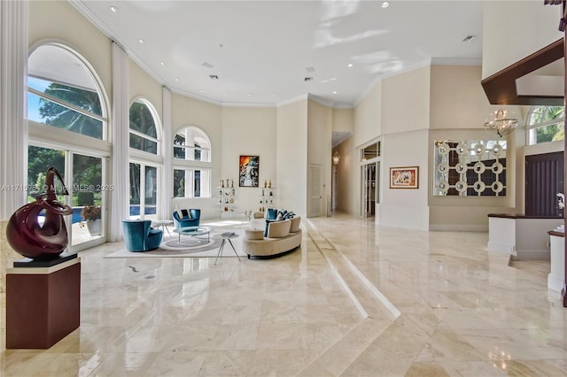 living room featuring a high ceiling and crown molding