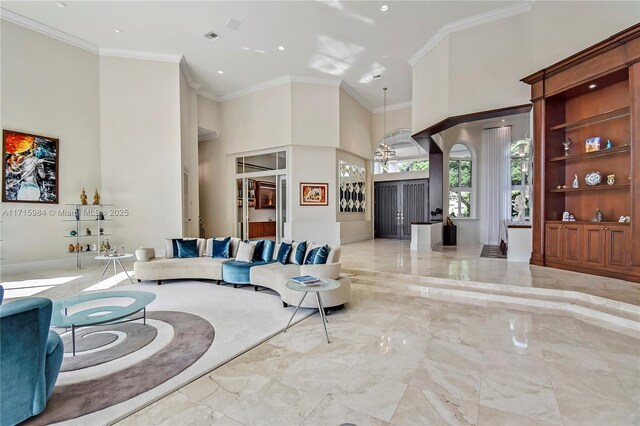 living room featuring crown molding and a notable chandelier