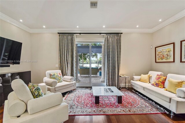 living room featuring hardwood / wood-style flooring and crown molding