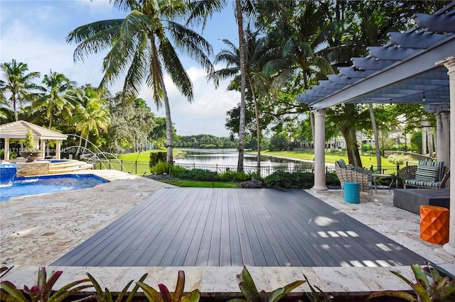 exterior space with pool water feature, a swimming pool with hot tub, and a water view