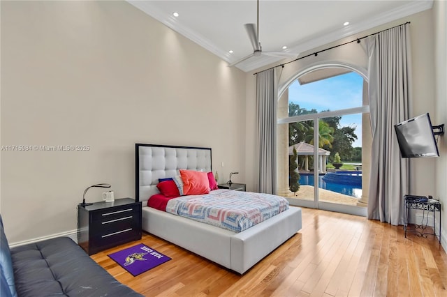 bedroom featuring wood-type flooring, crown molding, and access to outside