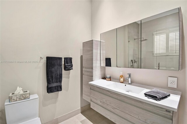 bathroom featuring tile patterned floors, vanity, toilet, and a shower with door