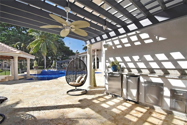 view of patio / terrace with a gazebo, area for grilling, ceiling fan, and pool water feature