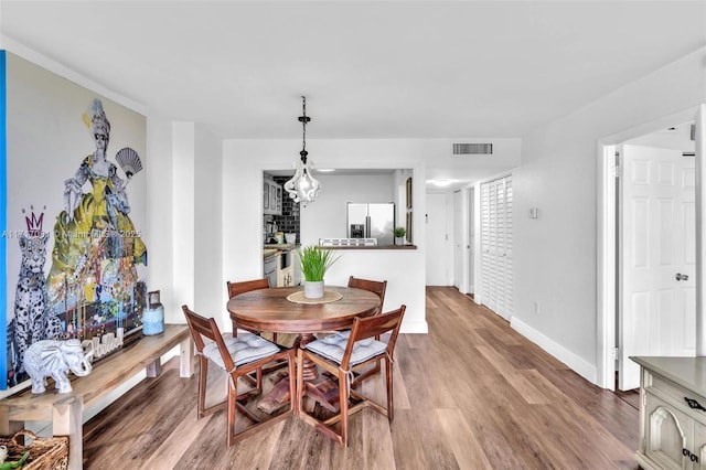 dining area featuring hardwood / wood-style floors and a fireplace