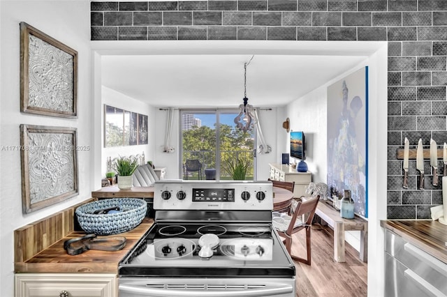 kitchen with stainless steel range with electric stovetop and light wood-type flooring