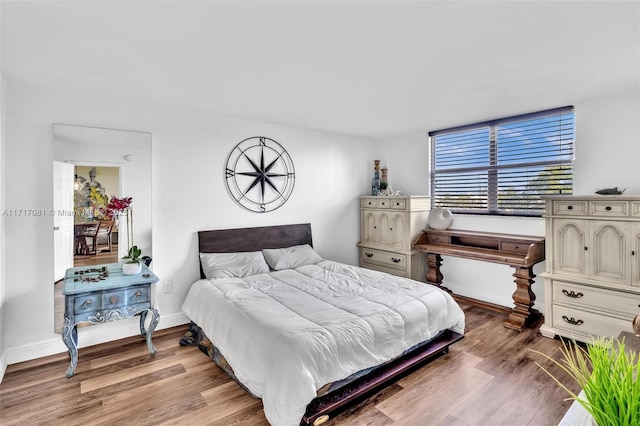 bedroom with hardwood / wood-style flooring