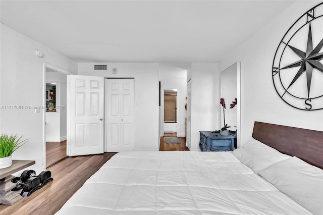 bedroom with a closet and hardwood / wood-style floors