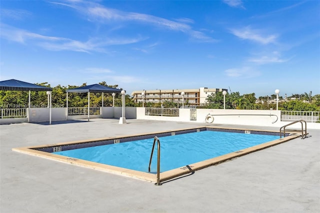 view of swimming pool with a gazebo and a patio